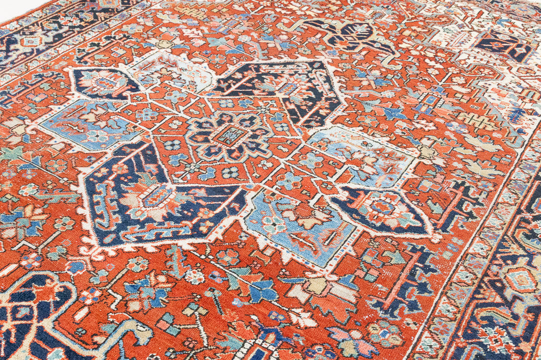 This a Vintage Persian Rug from Heriz in Persia. This hand woven Carpet features a lovely red ground with a central medallion design.