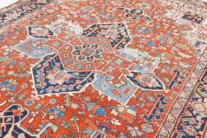 This a Vintage Persian Rug from Heriz in Persia. This hand woven Carpet features a lovely red ground with a central medallion design.