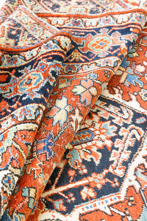 This a Vintage Persian Rug from Heriz in Persia. This hand woven Carpet features a lovely red ground with a central medallion design.