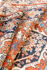 This a Vintage Persian Rug from Heriz in Persia. This hand woven Carpet features a lovely red ground with a central medallion design.