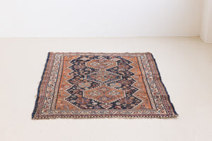This a Vintage Persian Rug from Quahqai in Persia. This hand woven Carpet features a red ground with an all over nature themed design.