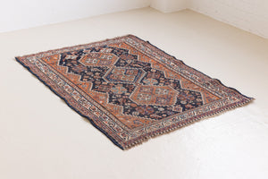 This a Vintage Persian Rug from Quahqai in Persia. This hand woven Carpet features a red ground with an all over nature themed design.