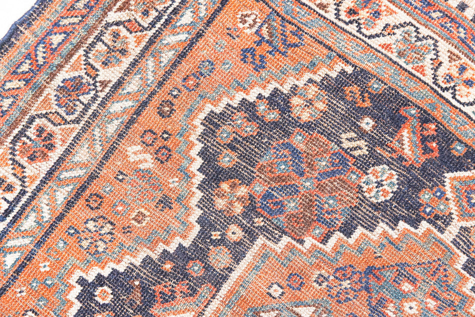 This a Vintage Persian Rug from Quahqai in Persia. This hand woven Carpet features a red ground with an all over nature themed design.