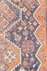 This a Vintage Persian Rug from Quahqai in Persia. This hand woven Carpet features a red ground with an all over nature themed design.