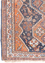 This a Vintage Persian Rug from Quahqai in Persia. This hand woven Carpet features a red ground with an all over nature themed design.