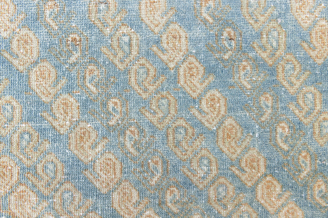 This is an Vintage Qashqai nomadic rug featuring a soft natural blue and orange with beautifully intricate designs within this handwoven carpet, a repeating boteh pattern frames the central diamond motifs.