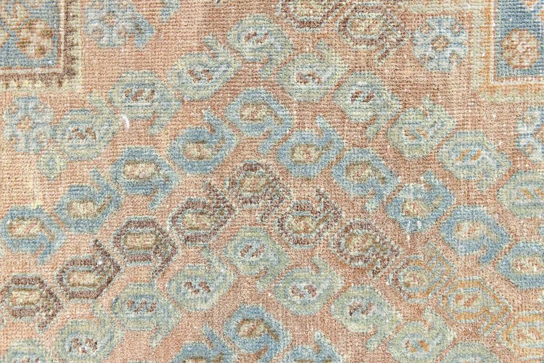 This is an Vintage Qashqai nomadic rug featuring a soft natural blue and orange with beautifully intricate designs within this handwoven carpet, a repeating boteh pattern frames the central diamond motifs.