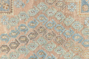 This is an Vintage Qashqai nomadic rug featuring a soft natural blue and orange with beautifully intricate designs within this handwoven carpet, a repeating boteh pattern frames the central diamond motifs.
