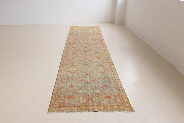 Marisa is a Persian Malayer runner with a beautiful palette of blues and terracotta and a wonderful patina. The pretty floral motif repeats throughout the length of the runner.