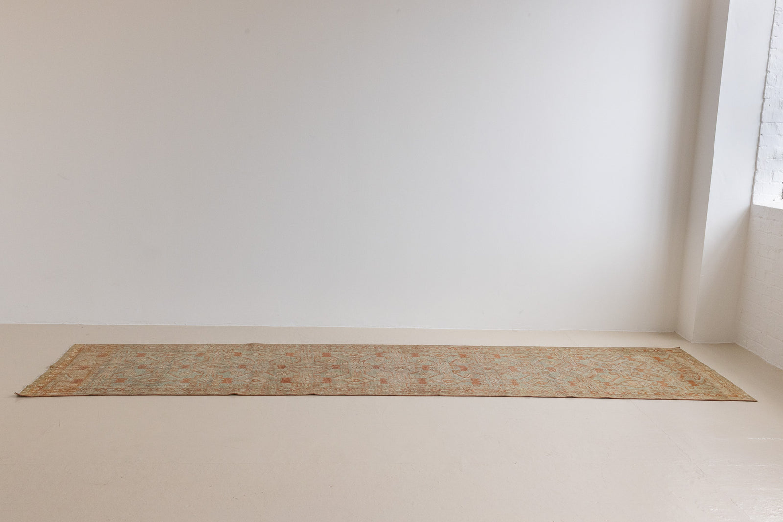 Marisa is a Persian Malayer runner with a beautiful palette of blues and terracotta and a wonderful patina. The pretty floral motif repeats throughout the length of the runner.