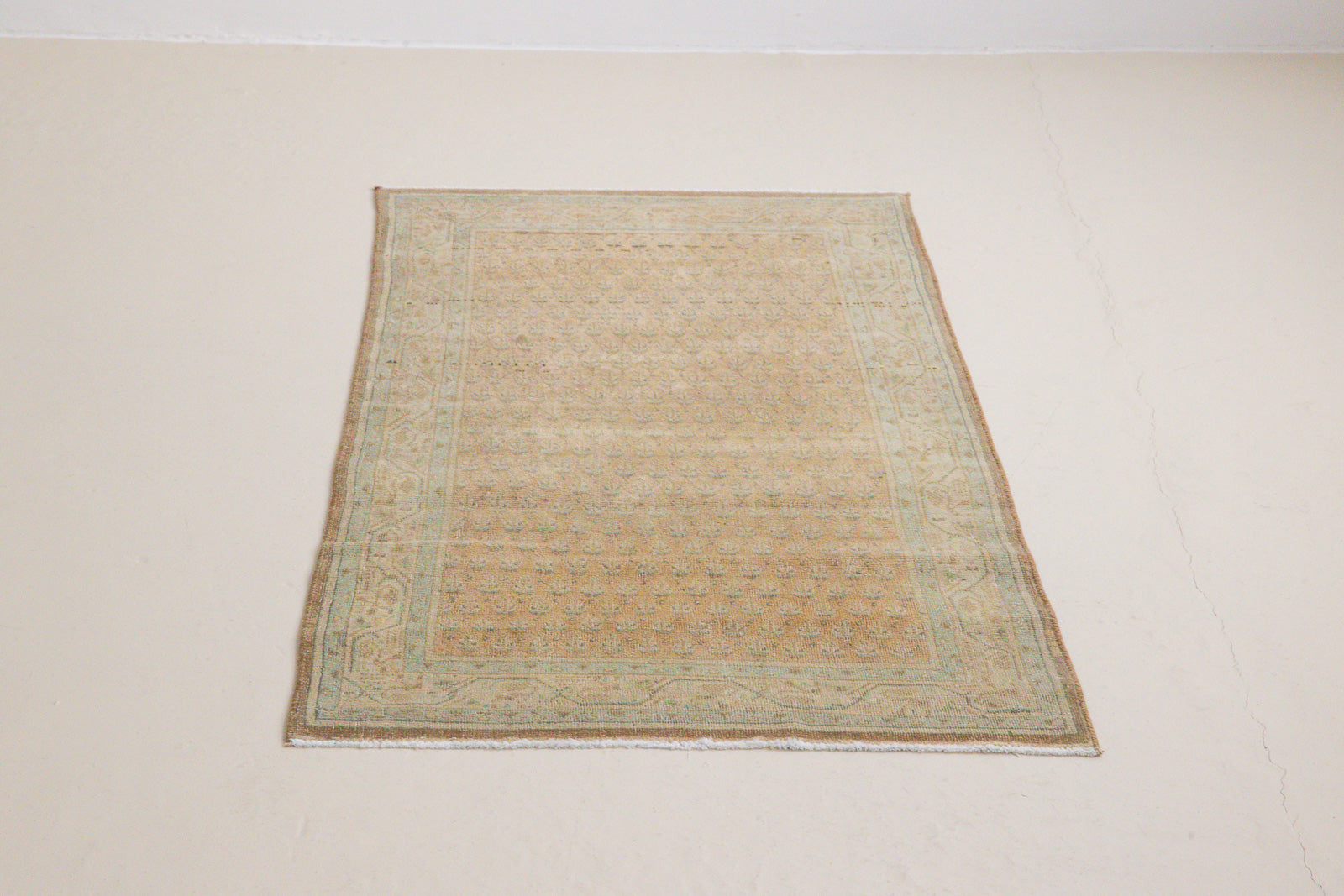 Jemima is a vintage rug handwoven in Turkey approximately 80 years ago. This rug features the classic boteh or paisley design and a refined, soft colour palette.