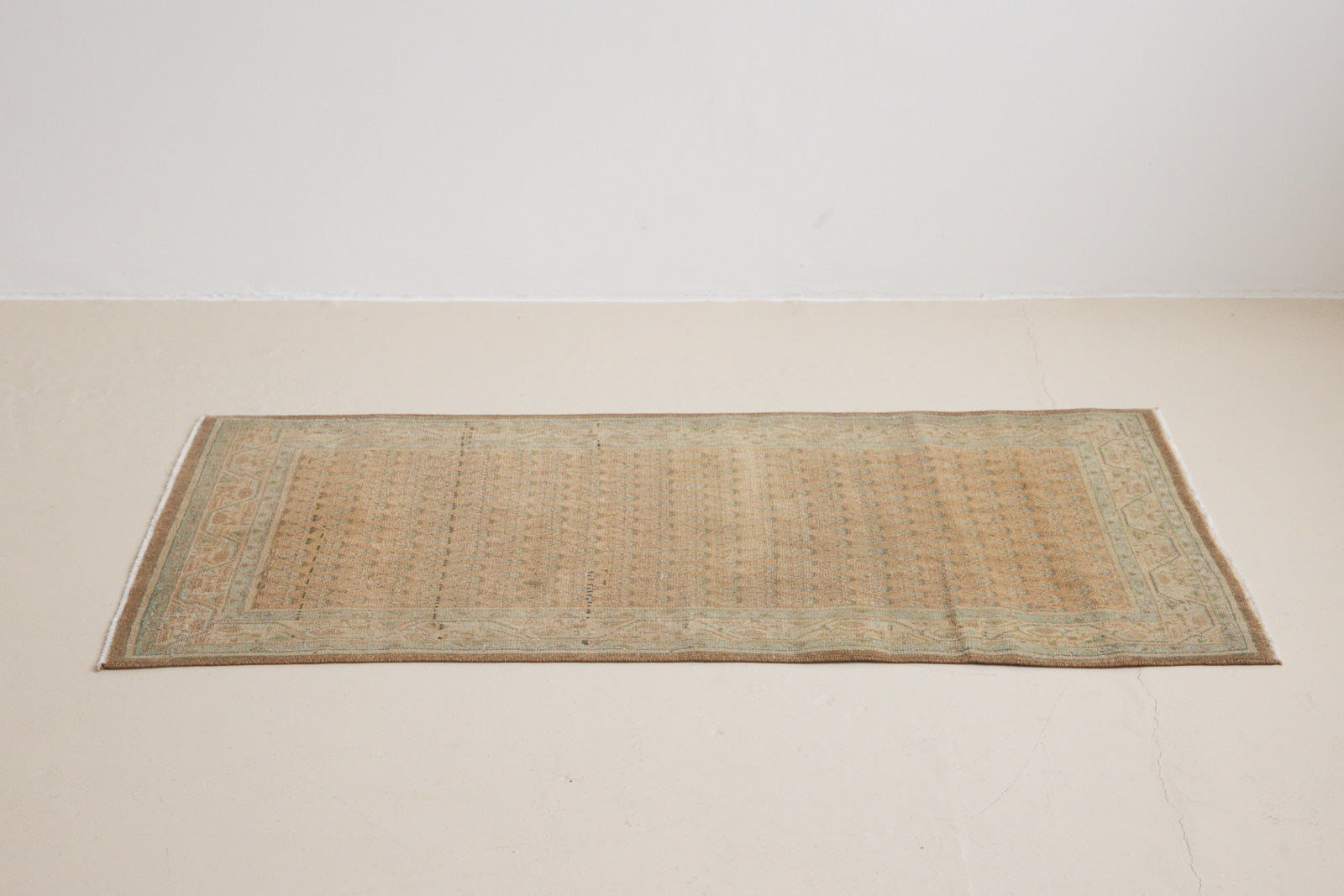 Jemima is a vintage rug handwoven in Turkey approximately 80 years ago. This rug features the classic boteh or paisley design and a refined, soft colour palette.