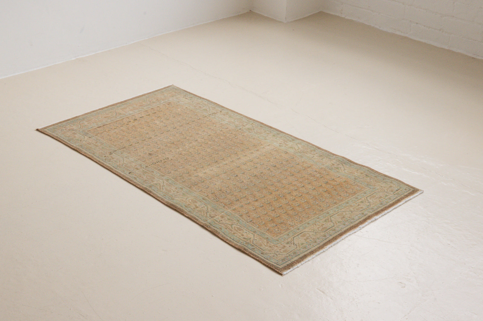 Jemima is a vintage rug handwoven in Turkey approximately 80 years ago. This rug features the classic boteh or paisley design and a refined, soft colour palette.