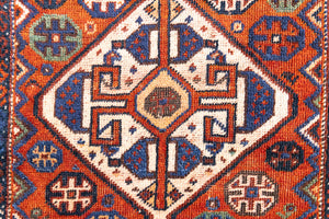 Gigi features a striking central diamond medallion, a classic motif in Qashqai weaving, framed by a repeating floral and gul pattern and a boteh patterned boarder.
