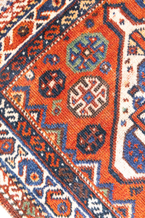 Gigi features a striking central diamond medallion, a classic motif in Qashqai weaving, framed by a repeating floral and gul pattern and a boteh patterned boarder.