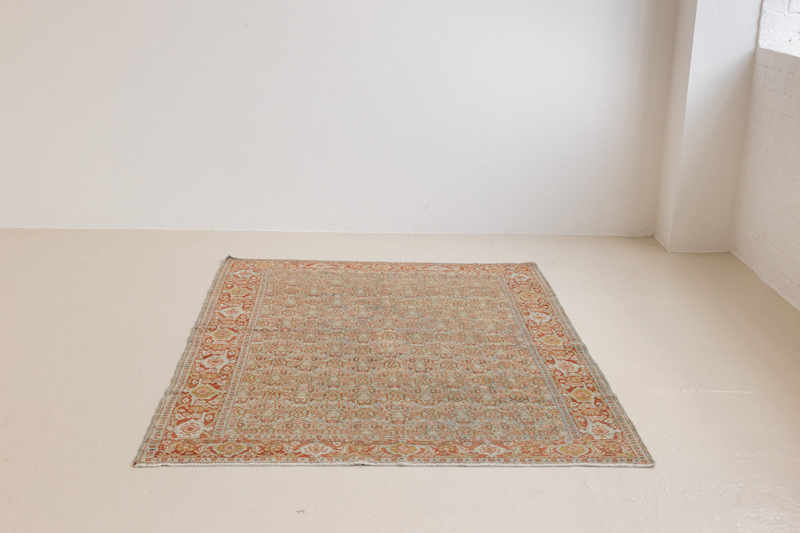Tabriz rugs are celebrated for their incredible precision, calm symmetry and intricate designs. This piece features a stunning all over Herati pattern and an incredible palette of soft terracotta and sky blue.
