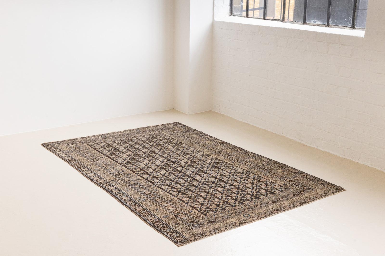 Liberty is a handmade Malayer rug, woven in the North West of Persia. This vintage carpet features a beautifully intricate repeating design and a rare colour palette.