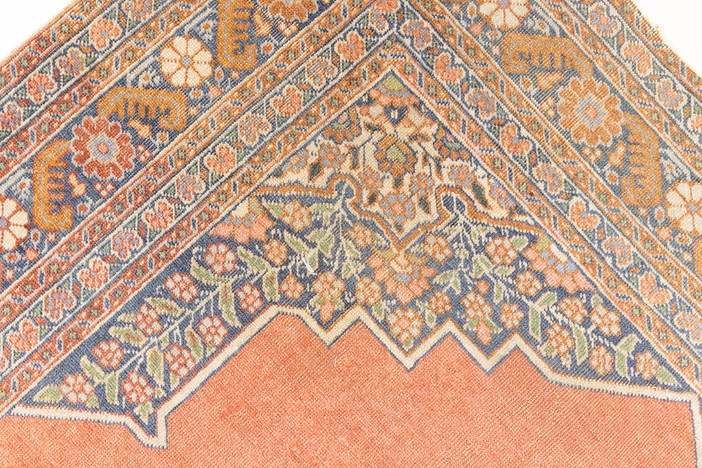 Selma is a beautiful antique Persian Tabriz rug with a soft yet bold coral colour palette and a stunning abrash and patina with a lovely central medallion.