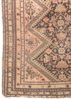 This a Vintage Persian Rug from Qashqai in Persia. This hand woven Carpet features a lovely pink and dark brown colour palette with a central medallion design.