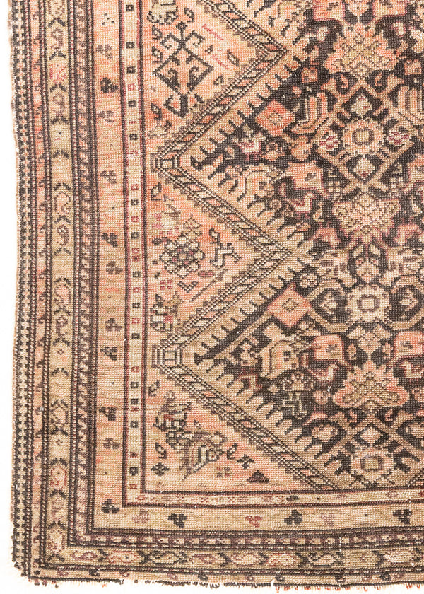 This a Vintage Persian Rug from Qashqai in Persia. This hand woven Carpet features a lovely pink and dark brown colour palette with a central medallion design.