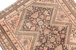 This a Vintage Persian Rug from Qashqai in Persia. This hand woven Carpet features a lovely pink and dark brown colour palette with a central medallion design.