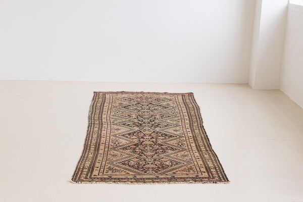 This a Vintage Persian Rug from Qashqai in Persia. This hand woven Carpet features a lovely pink and dark brown colour palette with a central medallion design.