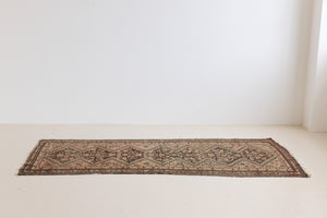 This a Vintage Persian Rug from Qashqai in Persia. This hand woven Carpet features a lovely pink and dark brown colour palette with a central medallion design.