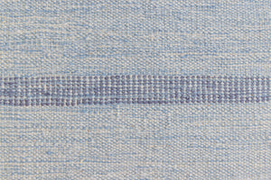 Hallie is an large original röllakan flat weave from the 1960s. This rug shows beautiful tones of blue, featuring bold geometric design with hints of pink within the motifs.