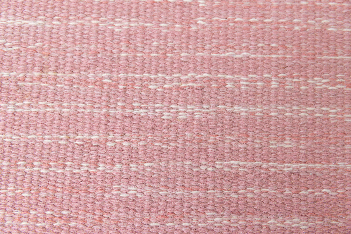 Kara is a vintage Swedish flatweave rug by Ingegerd Silow, featuring a soft pink field, denim blue ground and a pretty and stylised floral border. A leading figure in mid-century Swedish textile design, Silow is known for balancing traditional Nordic craftsmanship with a more decorative, expressive sensibility. This vintage rug features this signature style in its subtle yet playful floral border set against a calm field.
