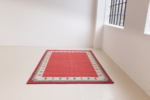 Tuva is a vintage rug handwoven in Sweden by the textile designer Ingegerd Silow. This piece features a rare red ground and sought after design.