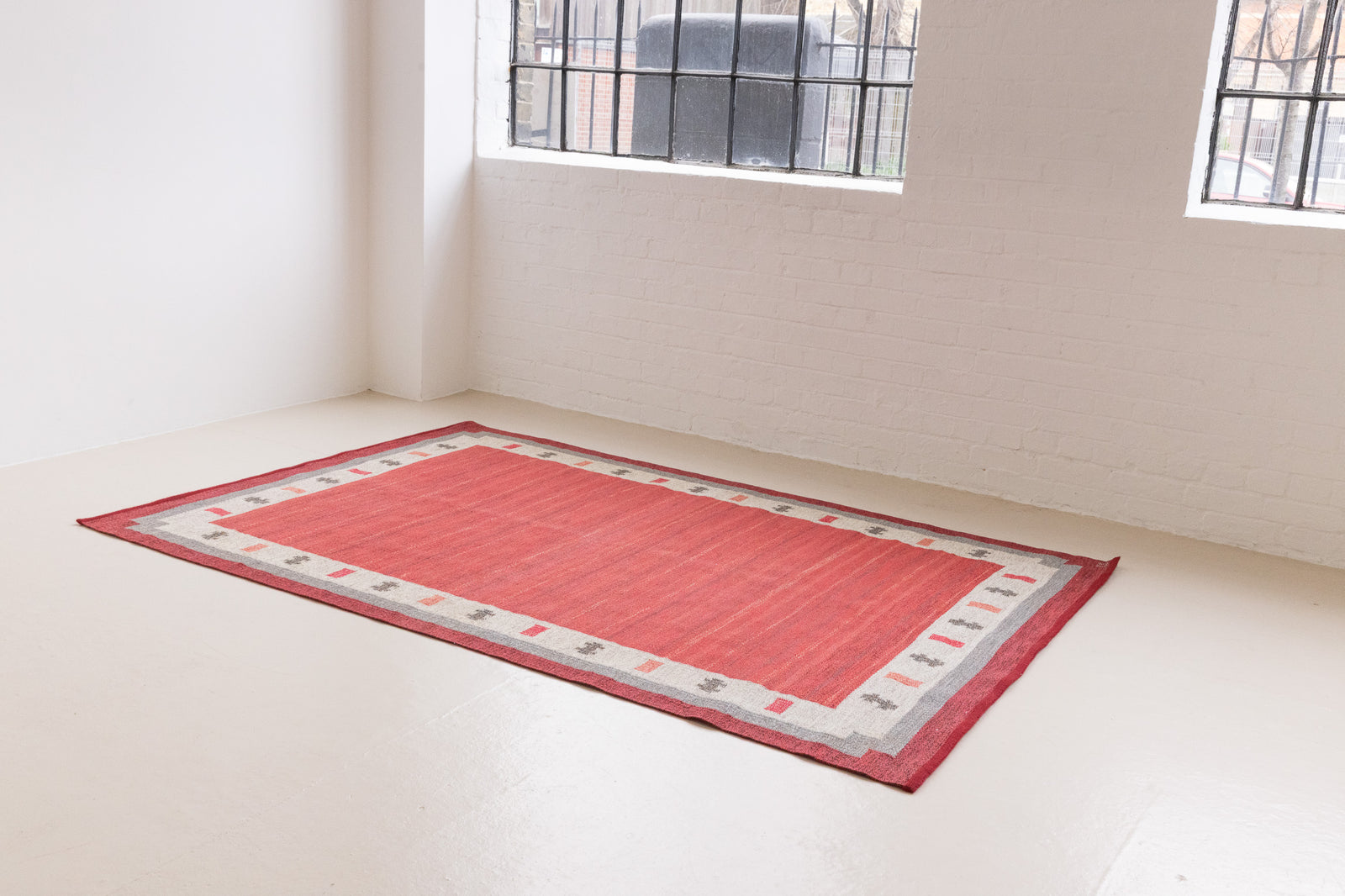 Tuva is a vintage rug handwoven in Sweden by the textile designer Ingegerd Silow. This piece features a rare red ground and sought after design.