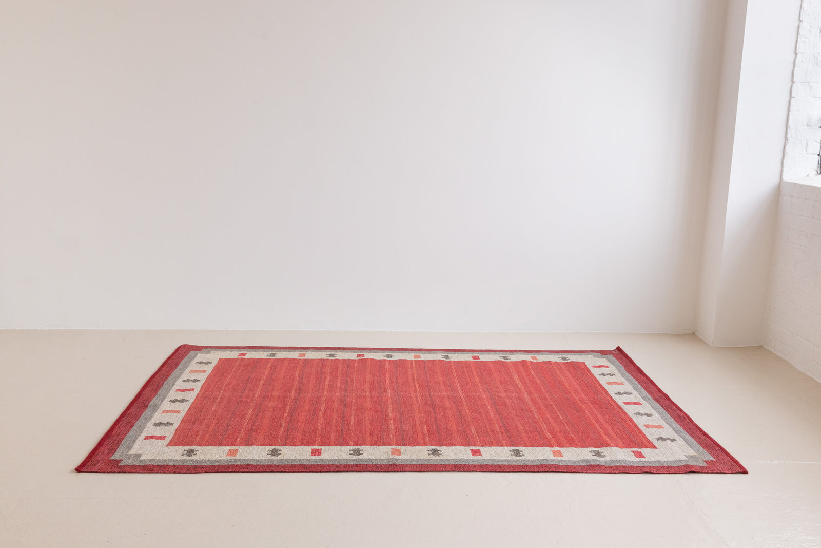 Tuva is a vintage rug handwoven in Sweden by the textile designer Ingegerd Silow. This piece features a rare red ground and sought after design.
