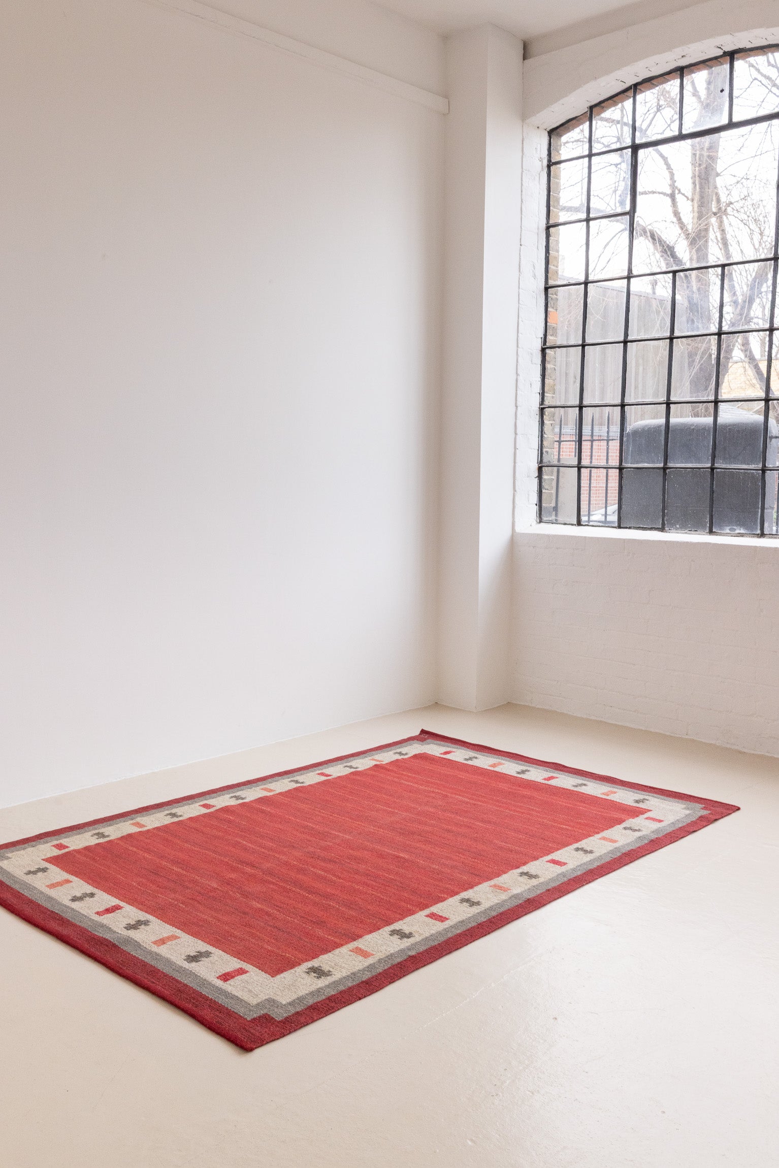 Tuva is a vintage rug handwoven in Sweden by the textile designer Ingegerd Silow. This piece features a rare red ground and sought after design.