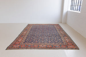 This a Vintage Persian Rug from Heriz in Persia. This hand woven Carpet features a lovely rust red and khaki green colour palette with a central medallion design.