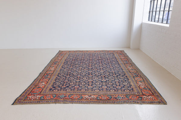 This a Vintage Persian Rug from Heriz in Persia. This hand woven Carpet features a lovely rust red and khaki green colour palette with a central medallion design.