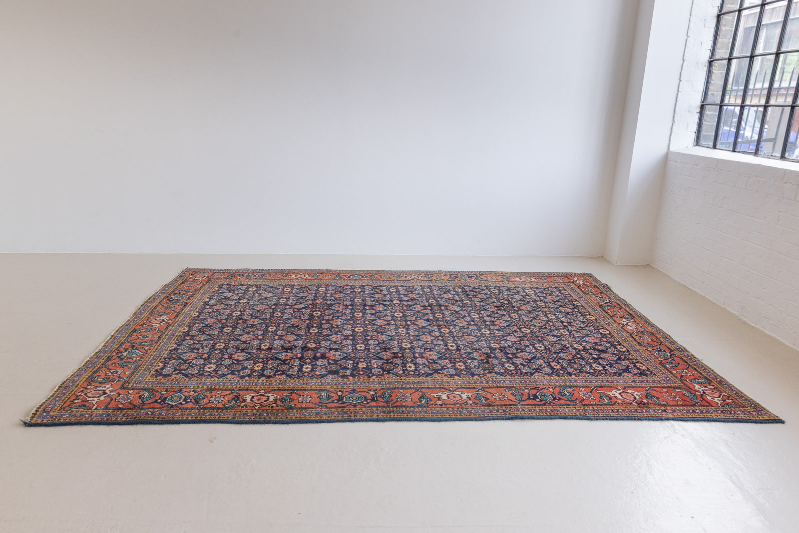 This a Vintage Persian Rug from Heriz in Persia. This hand woven Carpet features a lovely rust red and khaki green colour palette with a central medallion design.