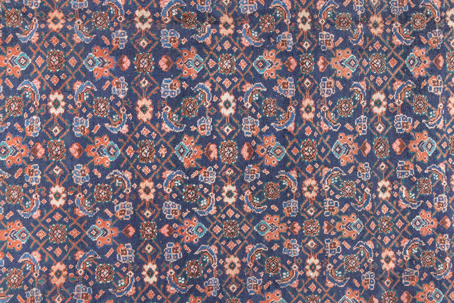 This a Vintage Persian Rug from Heriz in Persia. This hand woven Carpet features a lovely rust red and khaki green colour palette with a central medallion design.
