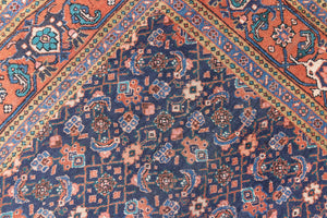 This a Vintage Persian Rug from Heriz in Persia. This hand woven Carpet features a lovely rust red and khaki green colour palette with a central medallion design.