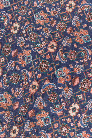 This a Vintage Persian Rug from Heriz in Persia. This hand woven Carpet features a lovely rust red and khaki green colour palette with a central medallion design.