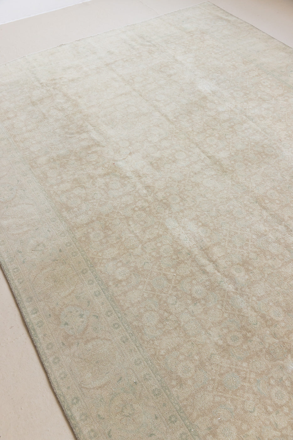 Misty is an antique Persian Tabriz rug which has been over-dyed using a special technique to gently fade its original colours, creating a stunning soft palette on this handwoven carpet from Persia.