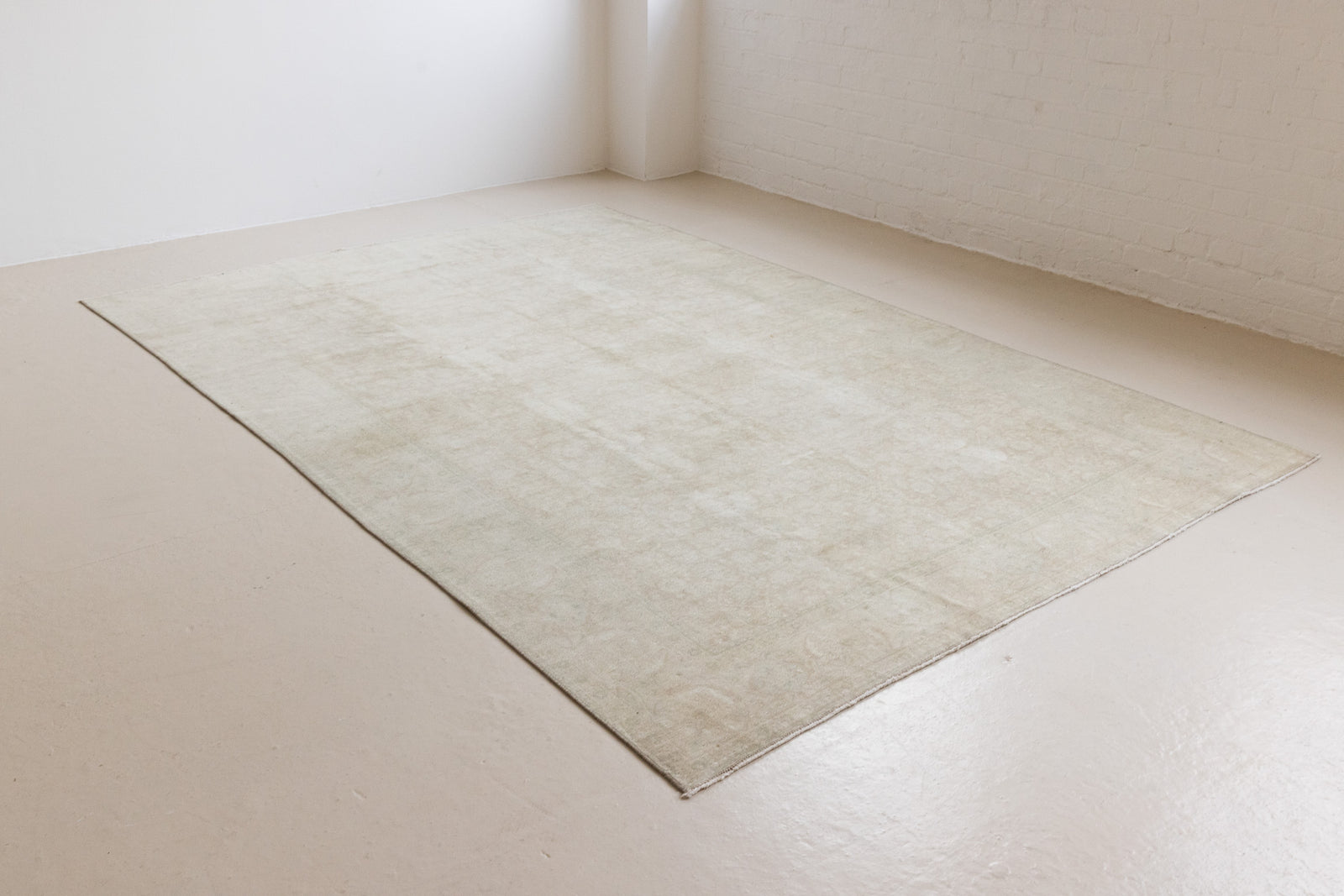 Misty is an antique Persian Tabriz rug which has been over-dyed using a special technique to gently fade its original colours, creating a stunning soft palette on this handwoven carpet from Persia.