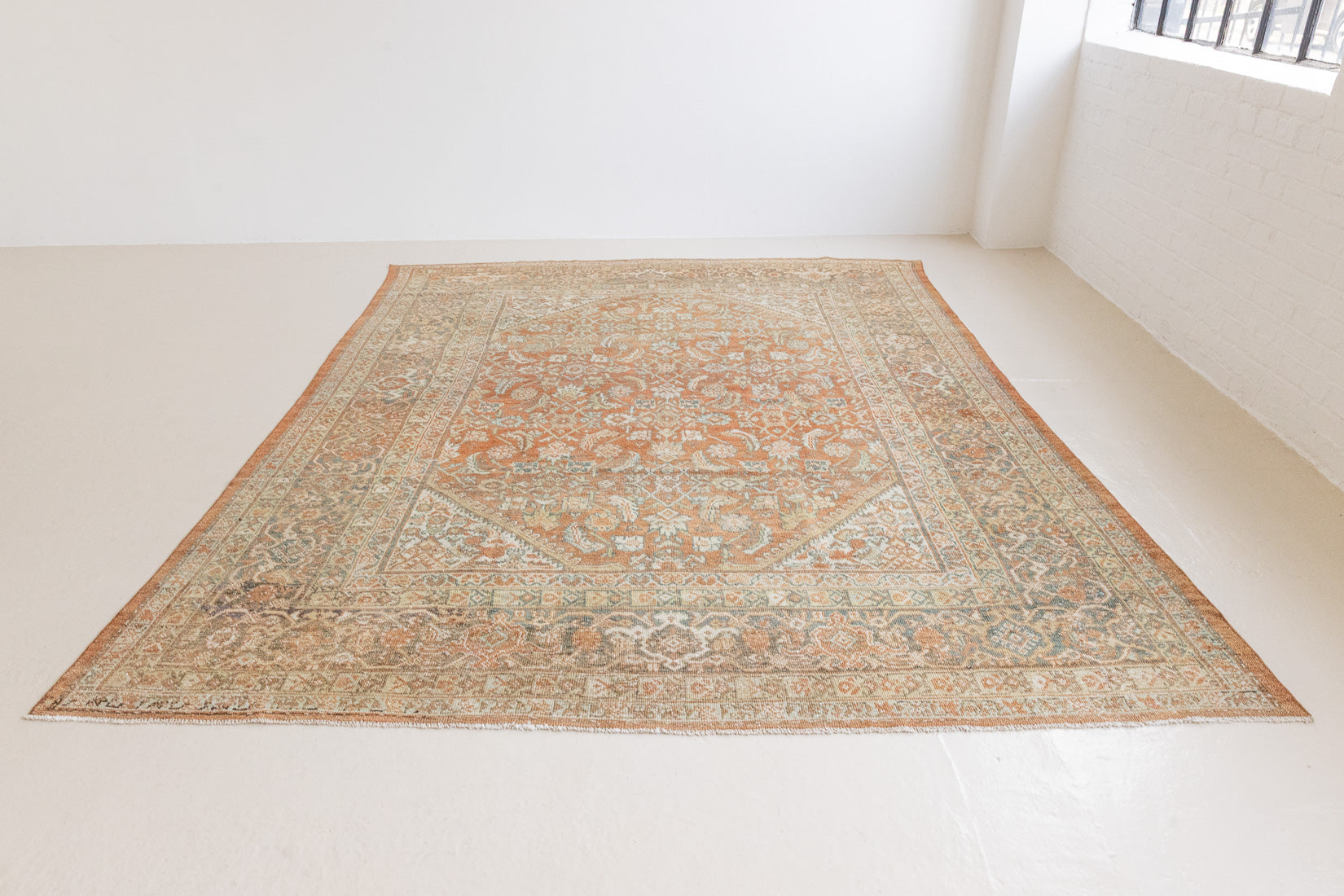 This is a Persian Mahal rug with a beautiful palette of reds oranges blues and a wonderful patina with lovely natural wear. Mahal in Persia produces the finest of carpets and this is one of them.