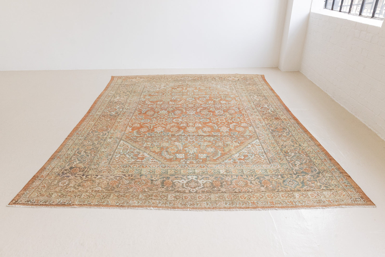 This is a Persian Mahal rug with a beautiful palette of reds oranges blues and a wonderful patina with lovely natural wear. Mahal in Persia produces the finest of carpets and this is one of them.