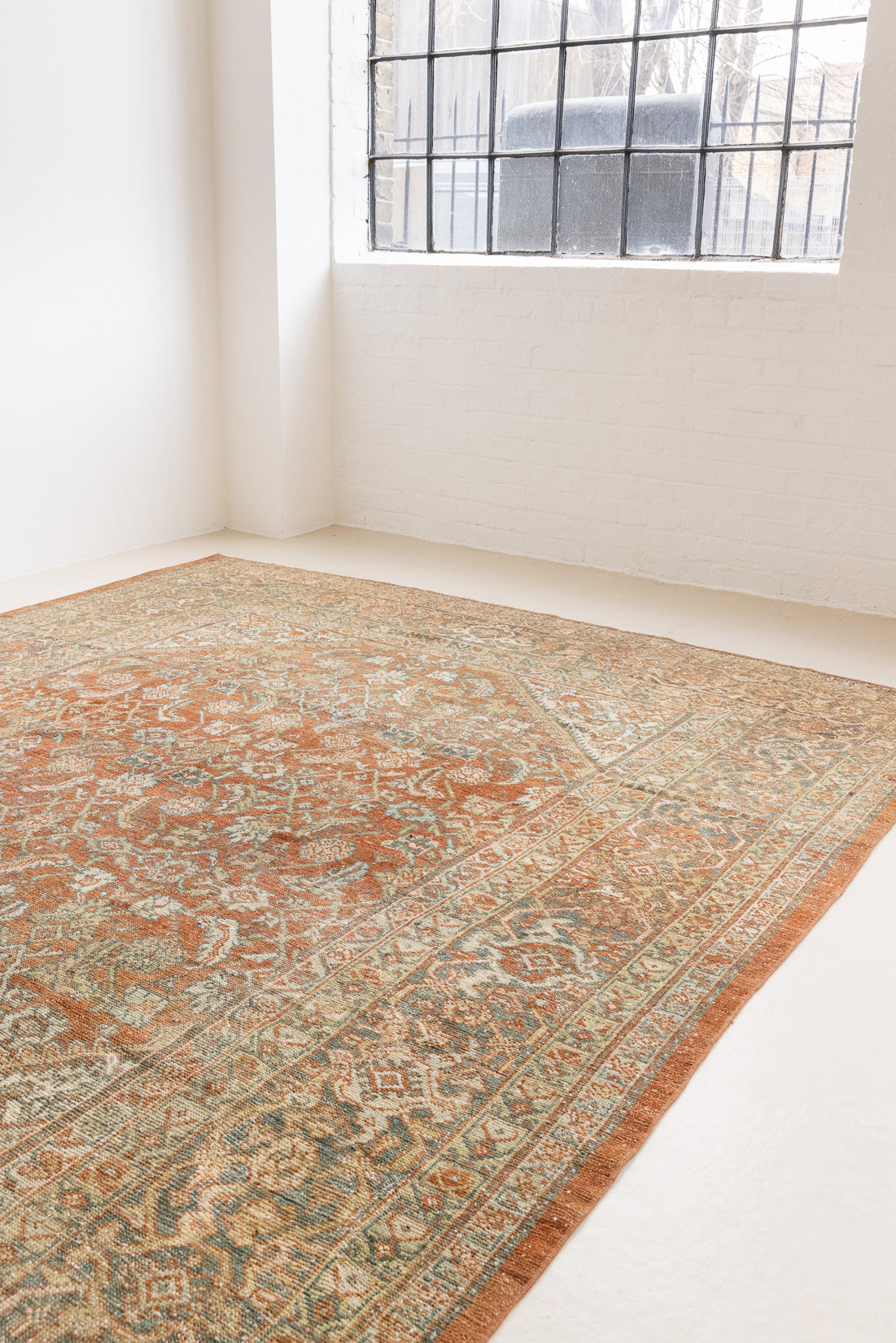 This is a Persian Mahal rug with a beautiful palette of reds oranges blues and a wonderful patina with lovely natural wear. Mahal in Persia produces the finest of carpets and this is one of them.