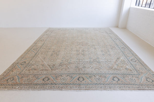 Handwoven antique Persian carpet with a muted taupe field and a decorative all-over floral design