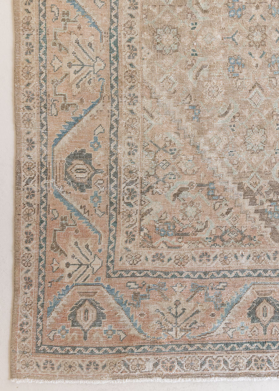 An antique Persian Mahal rug in soft taupe with gentle pink and blue accents