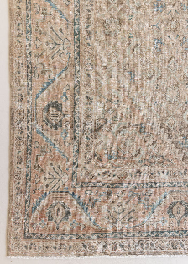 An antique Persian Mahal rug in soft taupe with gentle pink and blue accents