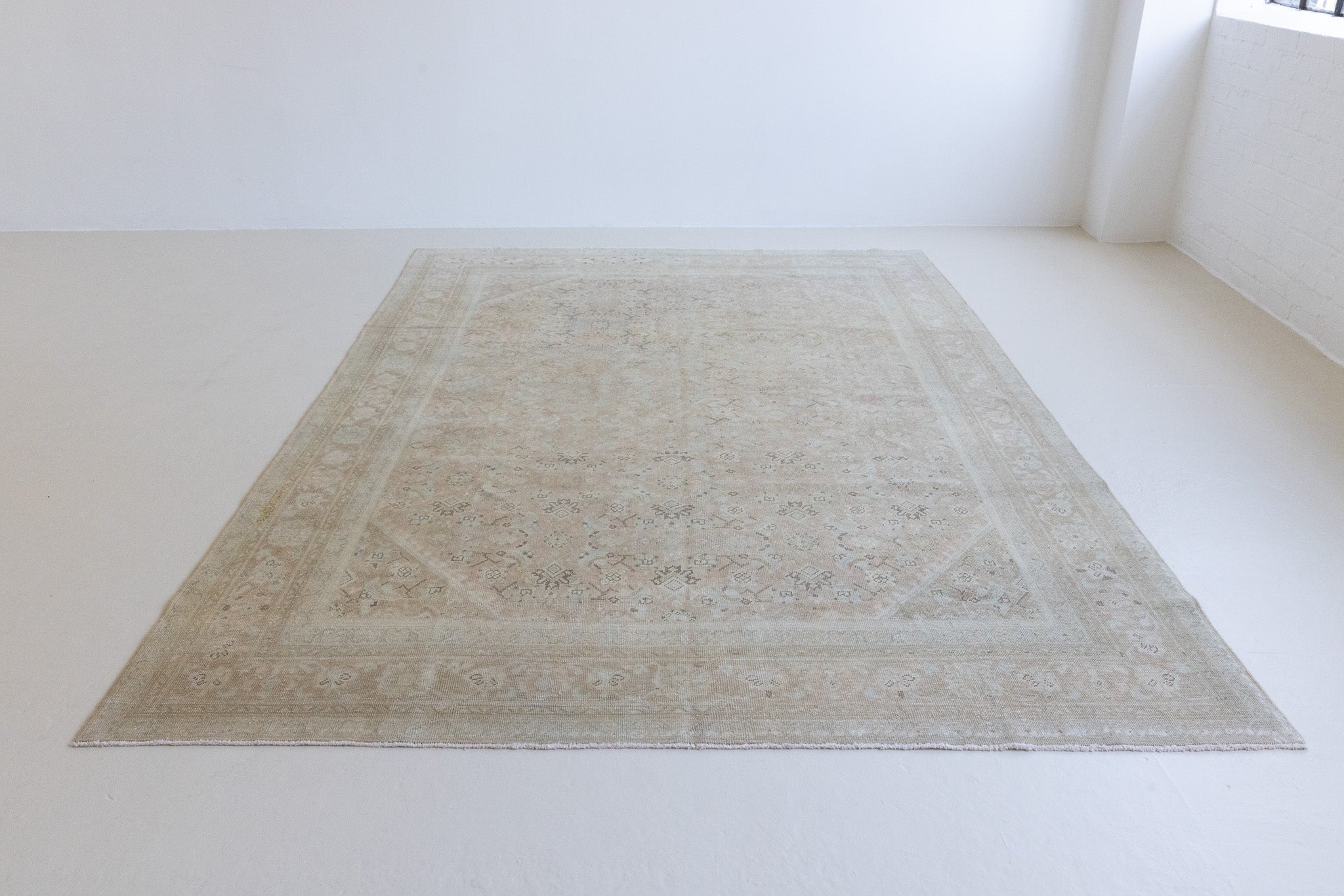 Handwoven antique Persian carpet with a pinky taupe field and a pretty, decorative blue floral pattern