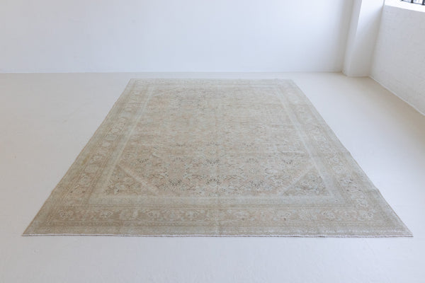 Handwoven antique Persian carpet with a pinky taupe field and a pretty, decorative blue floral pattern
