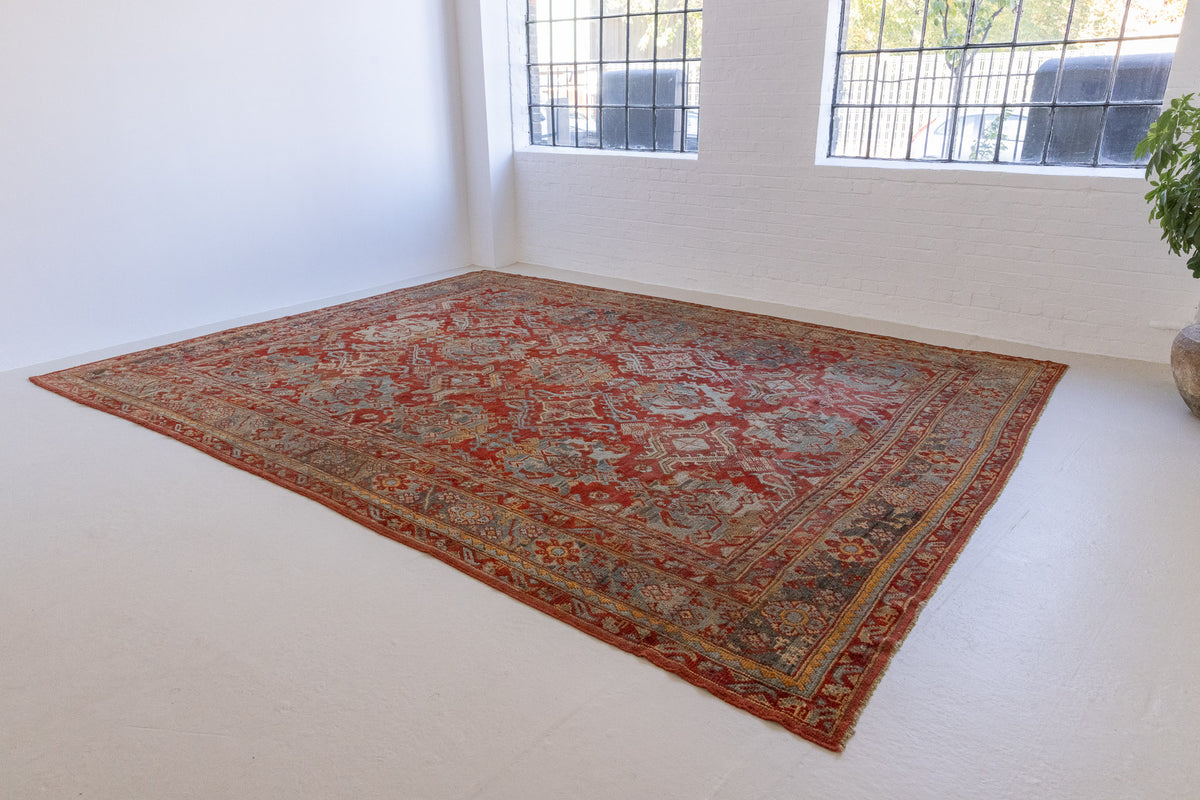 Antique Oushak rug from Western Anatolia, a handwoven wool carpet with rich, saturated colours